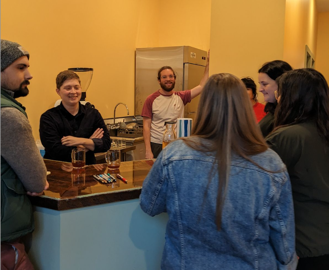 Liz serving coffee at topia coffee cooperative.